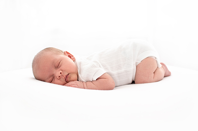 sleeping baby on white beanbag